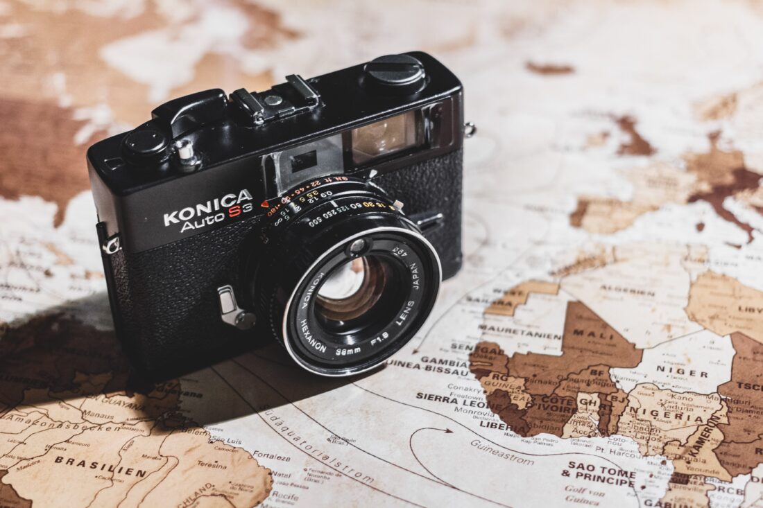 Old Camera Sitting on Map