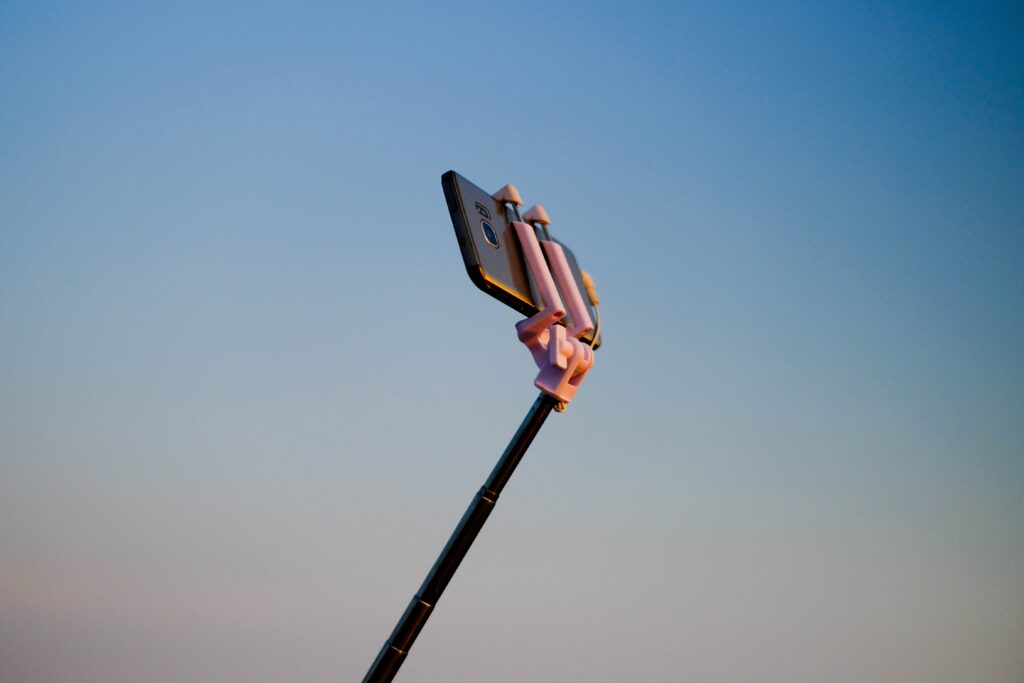 Cell phone in the air connected to a selfie stick